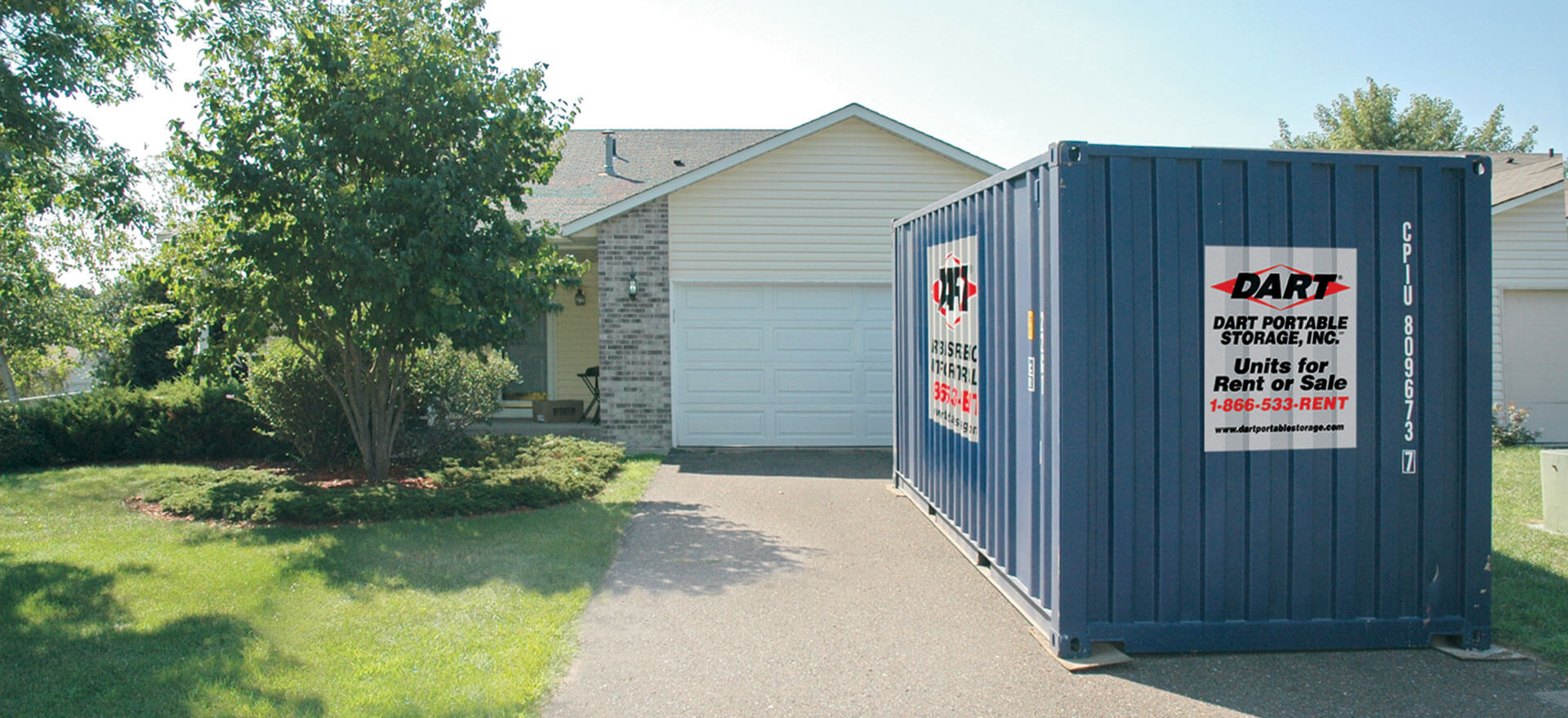Blue Dart Portable Storage container placed in front of suburban home