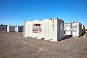 Multiple Dart Portable Storage units lined up on paved lot under blue sky