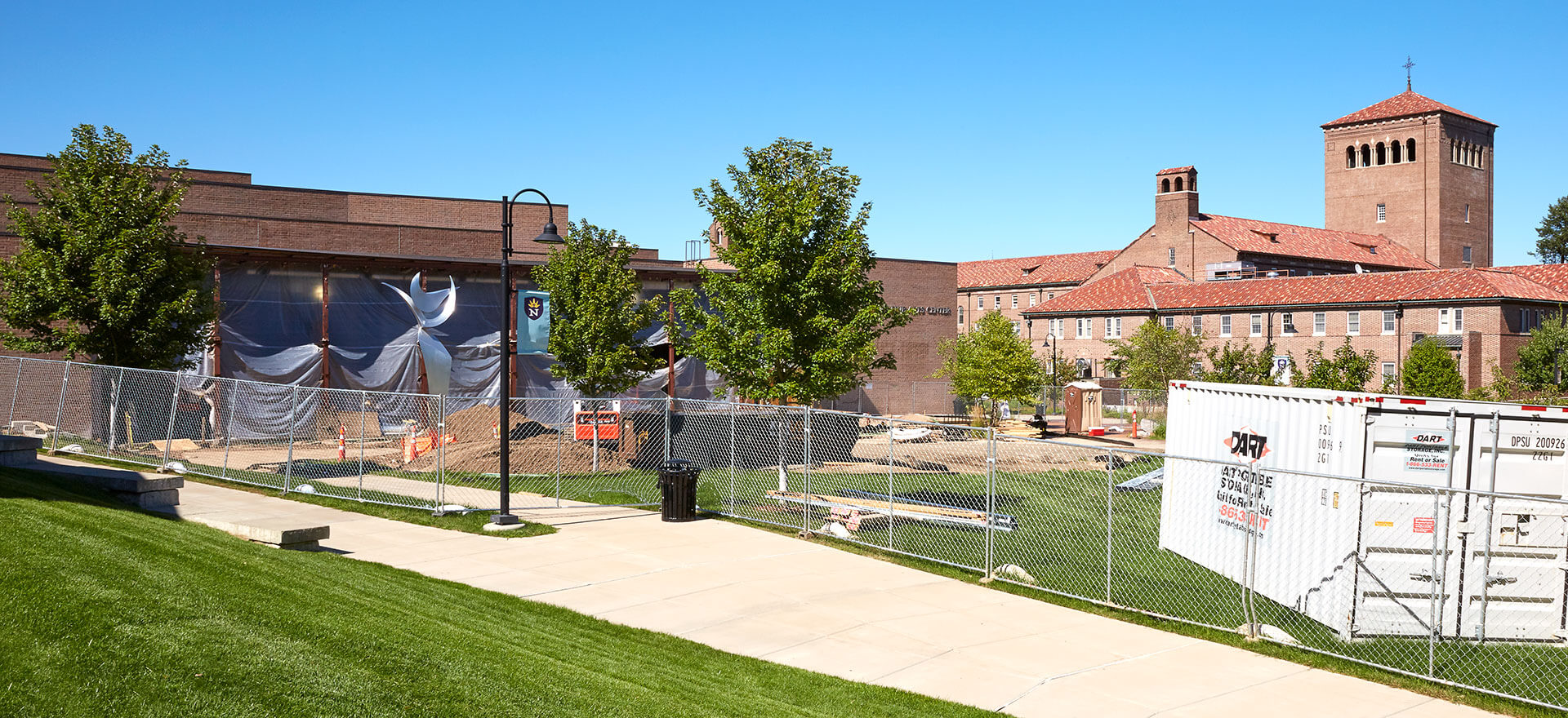 Dart Portable Storage container next to campus construction site with brick buildings